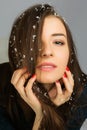 Portrait of the beautiful young woman with long brown hair posing at studio over dark background Royalty Free Stock Photo