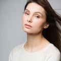 Portrait beautiful young woman with long brown hair. Pretty model poses at studio.