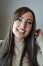 Portrait of a beautiful young woman with long brown hair smiling happily Royalty Free Stock Photo