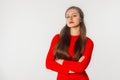 Portrait of beautiful young woman with long hair. Confident businesswoman with crossed arms looking at camera, standing against Royalty Free Stock Photo