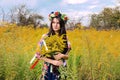 Portrait of a beautiful young woman with long hair, with a wreath with artificial flowers on her head Royalty Free Stock Photo