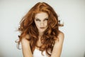 Portrait of a beautiful young woman with long red curly hair and freckles Royalty Free Stock Photo