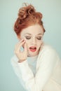 Portrait of a beautiful young woman with long red curly hair and perfect make up Royalty Free Stock Photo