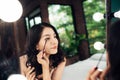 Portrait of beautiful young woman looking at the mirror applying Royalty Free Stock Photo