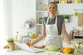 Beautiful young woman making salad at home Royalty Free Stock Photo