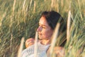 Portrait of a beautiful young woman on meadow watching the sunset enjoying nature summer evening outdoors Royalty Free Stock Photo