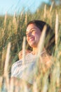 Portrait of a beautiful young woman on meadow watching the sunset enjoying nature summer evening outdoors Royalty Free Stock Photo