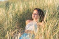 Portrait of a beautiful young woman on meadow watching the sunset enjoying nature summer evening outdoors Royalty Free Stock Photo