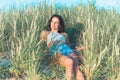 Portrait of a beautiful young woman on meadow watching the sunset enjoying nature summer evening outdoors Royalty Free Stock Photo