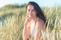 Portrait of a beautiful young woman on meadow watching the sunset enjoying nature summer evening outdoors Royalty Free Stock Photo