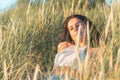 Portrait of a beautiful young woman on meadow watching the sunset enjoying nature summer evening outdoors Royalty Free Stock Photo