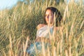 Portrait of a beautiful young woman on meadow watching the sunset enjoying nature summer evening outdoors Royalty Free Stock Photo