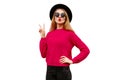 Portrait of beautiful young woman model blowing her red lips wearing pink knitted sweater and black round hat isolated on white Royalty Free Stock Photo