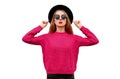 Portrait of beautiful young woman model blowing her red lips wearing pink knitted sweater and black round hat isolated on white Royalty Free Stock Photo