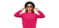 Portrait of beautiful young woman model blowing her red lips wearing pink knitted sweater and black round hat isolated on white Royalty Free Stock Photo