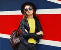 Portrait of beautiful young woman model wearing black round hat, jacket in the city Royalty Free Stock Photo