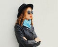 Portrait of beautiful young woman model wearing a black round hat, jacket, sunglasses Royalty Free Stock Photo