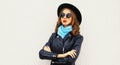 Portrait of beautiful young woman model wearing a black round hat, jacket, sunglasses Royalty Free Stock Photo