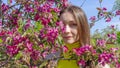 Portrait of beautiful young woman in paradise apple trees blooming park on a sunny day. Springtime. Red apple tree Royalty Free Stock Photo