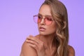 Portrait of beautiful young woman with perfect makeup wearing pink sunglasses. Royalty Free Stock Photo