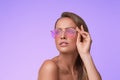 Portrait of beautiful young woman with perfect makeup wearing pink sunglasses. Royalty Free Stock Photo