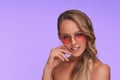 Portrait of beautiful young woman with perfect makeup wearing pink sunglasses. Royalty Free Stock Photo