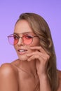 Portrait of beautiful young woman with perfect makeup wearing pink sunglasses. Royalty Free Stock Photo