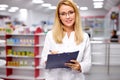 Portrait of beautiful young woman pharmacist at modern drugstore Royalty Free Stock Photo