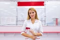 Portrait of beautiful young woman pharmacist at modern drugstore Royalty Free Stock Photo