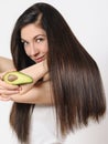 Portrait of a beautiful young woman posing with an avocado over white isolated background Royalty Free Stock Photo