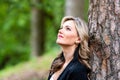 Portrait of a beautiful young woman posing near a tree Royalty Free Stock Photo