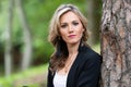 Portrait of a beautiful young woman posing near a tree Royalty Free Stock Photo