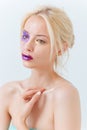 Portrait of beautiful young woman with purple creative makeup Royalty Free Stock Photo