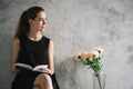 Portrait of a beautiful young woman reading book relaxing in living room. Vintage effect style pictures Royalty Free Stock Photo