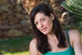 Portrait of beautiful young woman relaxing on grass with palm tr Royalty Free Stock Photo