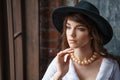 Portrait of a beautiful young woman in retro style in an elegant black hat Royalty Free Stock Photo