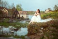 Portrait of a beautiful young woman by the river