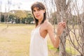 Portrait of a beautiful young woman in a short cream colored dress. Fashion, sensuality concept