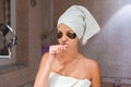 Portrait of a beautiful young woman after shower in patches. female brush teeth in front of her bathroom mirror. healty wellness Royalty Free Stock Photo