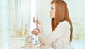 Beautiful young woman sitting near dressing table at home Royalty Free Stock Photo
