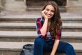 Portrait of a beautiful young woman sitting on stairs outdoors beautiful young woman smiling Royalty Free Stock Photo