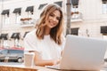 Portrait of beautiful young woman sitting at table in cafe outdo Royalty Free Stock Photo