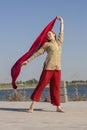 Portrait of a beautiful young woman sitting in yoga pose at the beach Royalty Free Stock Photo