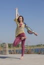 Portrait of a beautiful young woman sitting in yoga pose at the beach Royalty Free Stock Photo