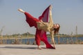 Portrait of a beautiful young woman sitting in yoga pose at the beach Royalty Free Stock Photo