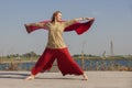 Portrait of a beautiful young woman sitting in yoga pose at the beach Royalty Free Stock Photo