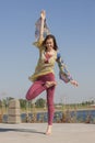 Portrait of a beautiful young woman sitting in yoga pose at the beach Royalty Free Stock Photo