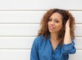 Portrait of a beautiful young woman smiling with hand in hair