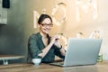 Portrait of a beautiful young woman smiling and looking at laptop screen Royalty Free Stock Photo