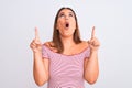 Portrait of beautiful young woman standing over isolated white background amazed and surprised looking up and pointing with Royalty Free Stock Photo